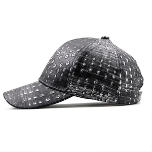 Detailed side view of black distressed PU leather baseball cap with silver metal stud patterns