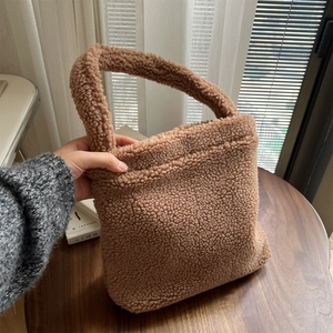 Detail of soft brown teddy faux fur texture on a compact winter handheld tote bag