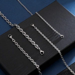 Detail of silver stainless steel cable chains with lobster clasps on a display stand