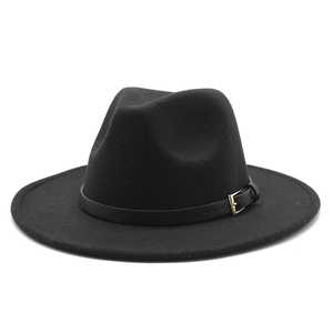 Detail of a black wool fedora featuring a stylish faux leather band and gold buckle accent