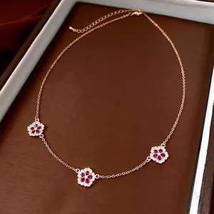 Luxury 18K gold plated necklace featuring three intricate red floral pendants with crystals