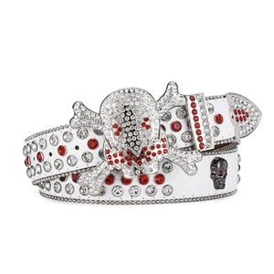 White leather belt with skull buckle and red rhinestones on a white studio background