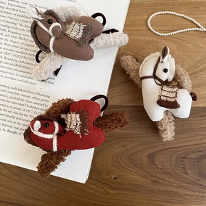 Detail view of handmade fabric horse hair scrunchies in red brown and white colors