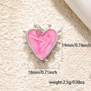 Detail view of 18mm heart pendant with size and weight measurements on a beige surface