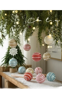 Detail of luxury pearl and glitter striped Christmas tree ornaments in festive setting