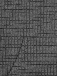 Detailed close-up of dark grey waffle quilted texture and pocket stitching on hoodie
