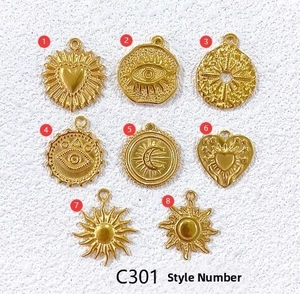 Detailed set of eight golden stainless steel charms featuring celestial and mystic motifs