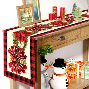Christmas table runner with poinsettia and pine cones on red and black buffalo plaid fabric
