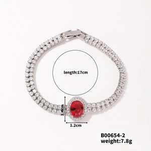 Macro detail of silver bracelet with red oval stone and cubic zirconia inlay