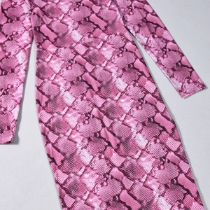 Gros plan sur l'imprimé serpent rose du tissu en soie glacée montrant la texture fine