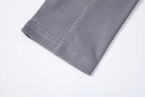 Macro shot of high-quality flat stitching on grey UV protection long sleeve shirt