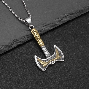 Nordic Viking double axe pendant necklace with golden eagle engraving on stone background