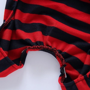 Detailed macro view of red and black striped dog pajamas showing elastic ribbed cuff texture