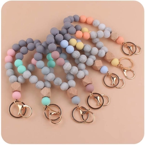 Detailed set of five colorful silicone and wood bead wristlet keychains with metal clasps