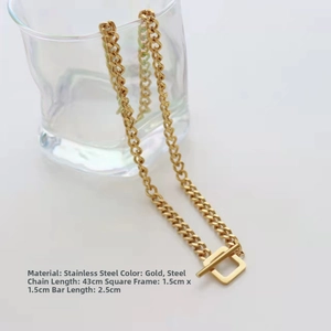 Detailed shot of gold OT buckle stainless steel necklace on a glass rim with size info