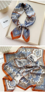 Close-up of paisley pattern silk square scarf showing folded texture and knotted style