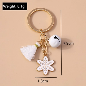 Detail shot of gold Christmas keychain with white bell tassel and snowflake pendant dimensions