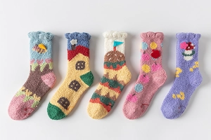 Close-up of five soft coral fleece socks with cute cartoon patterns like houses and flowers