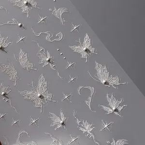3D embossed nail stickers featuring silver butterflies, stars, and pearls on a dark background
