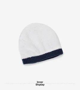 Dettaglio della spessa fodera in pile bianco e della maglia a coste blu scuro del berretto