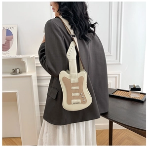 Detail of guitar-shaped crossbody bag with silver star studs and mixed color PU leather