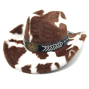 Close-up of cow print cowboy hat featuring a vintage bronze star and faux fur texture