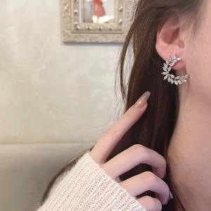 Elegant silver leaf wheat ear stud earrings with sparkling cubic zirconia on female model