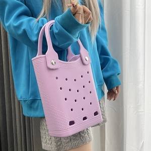 Close-up of lavender EVA tote bag featuring iconic perforated holes and silver rivet hardware