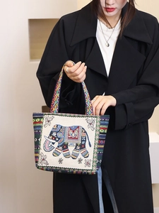Ethnic canvas tote bag featuring red and blue elephant embroidery with geometric straps