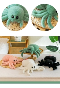 Detailed close-up of plush spider toys in green, pink, white, and black colors