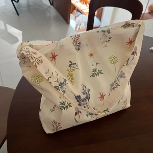 Detail of artistic floral canvas tote bag featuring hand-painted wildflower pattern