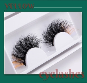 Detailed view of handmade faux mink eyelashes with natural black to yellow color gradient