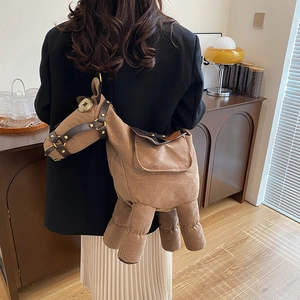 Whimsical brown plush horse-shaped crossbody bag worn with casual stylish outfit