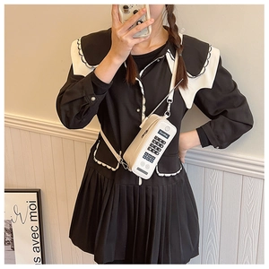Close-up of white creative phone-shaped crossbody bag with LoveBag detail and keypads