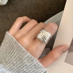 925 sterling silver square ring with hammered texture worn on a woman finger