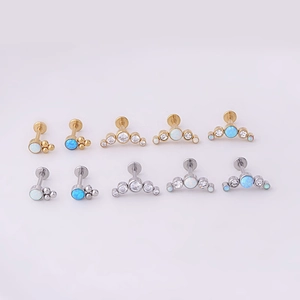 Detailed view of silver and gold 16G opal labret studs with cubic zirconia inlays