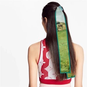 Detail of oil painting style silk ribbon scarf worn as a hair tie on a fashion model