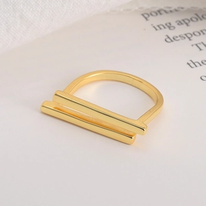 Minimalist parallel gold band ring with geometric T-shape design on aesthetic background