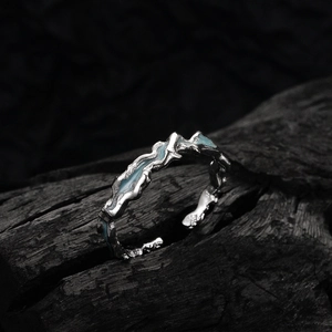 Minimalist S925 sterling silver ring with blue enamel mountain wave texture on dark wood