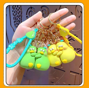Close-up of creative pear duck hug keychain with matte silicone texture and metal ring
