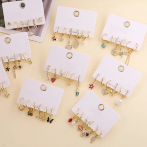 Detail view of Bohemian gold earring set featuring S925 posts with crystal and pearl charms