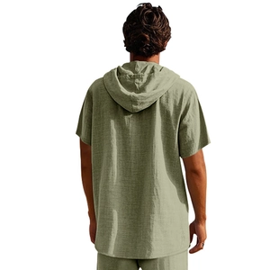 Back view of a man wearing a sage green linen short sleeve hoodie beach set on white background