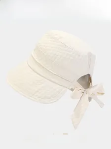 Detail of cream sun bucket hat with textured fabric and back bow decoration