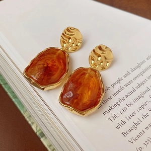 French vintage irregular amber resin oval earrings with gold hammered metal studs on book