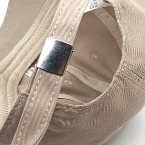 Macro detail of 100% cotton baseball cap with adjustable metal buckle at the back