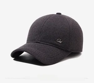 Detail of dark grey baseball cap featuring textured fabric and metal side decoration