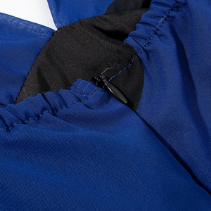 Detail of dark blue chiffon dress featuring hidden zipper and elastic pleated edges