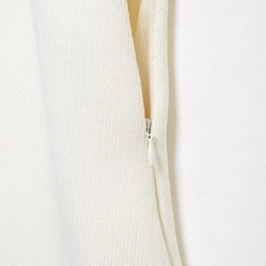 Elegant white pleated skirt featuring a hidden zipper and high-quality textured fabric