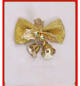 Detail of gold Christmas bow ornament featuring festive bells and holly leaf accents