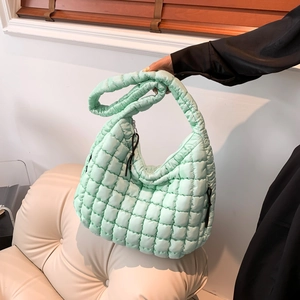 Mint green quilted hobo cloud bag with soft padded puffy texture and wide shoulder strap
